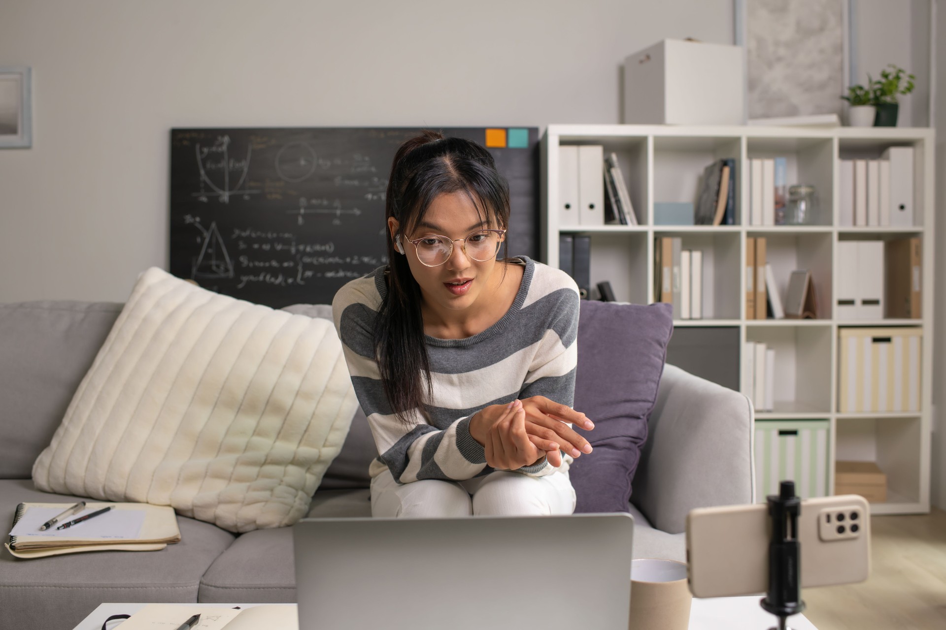 Young Asian teacher transforms her living space into an engaging online classroom,  teaching online with passion, concept of online teaching and education.